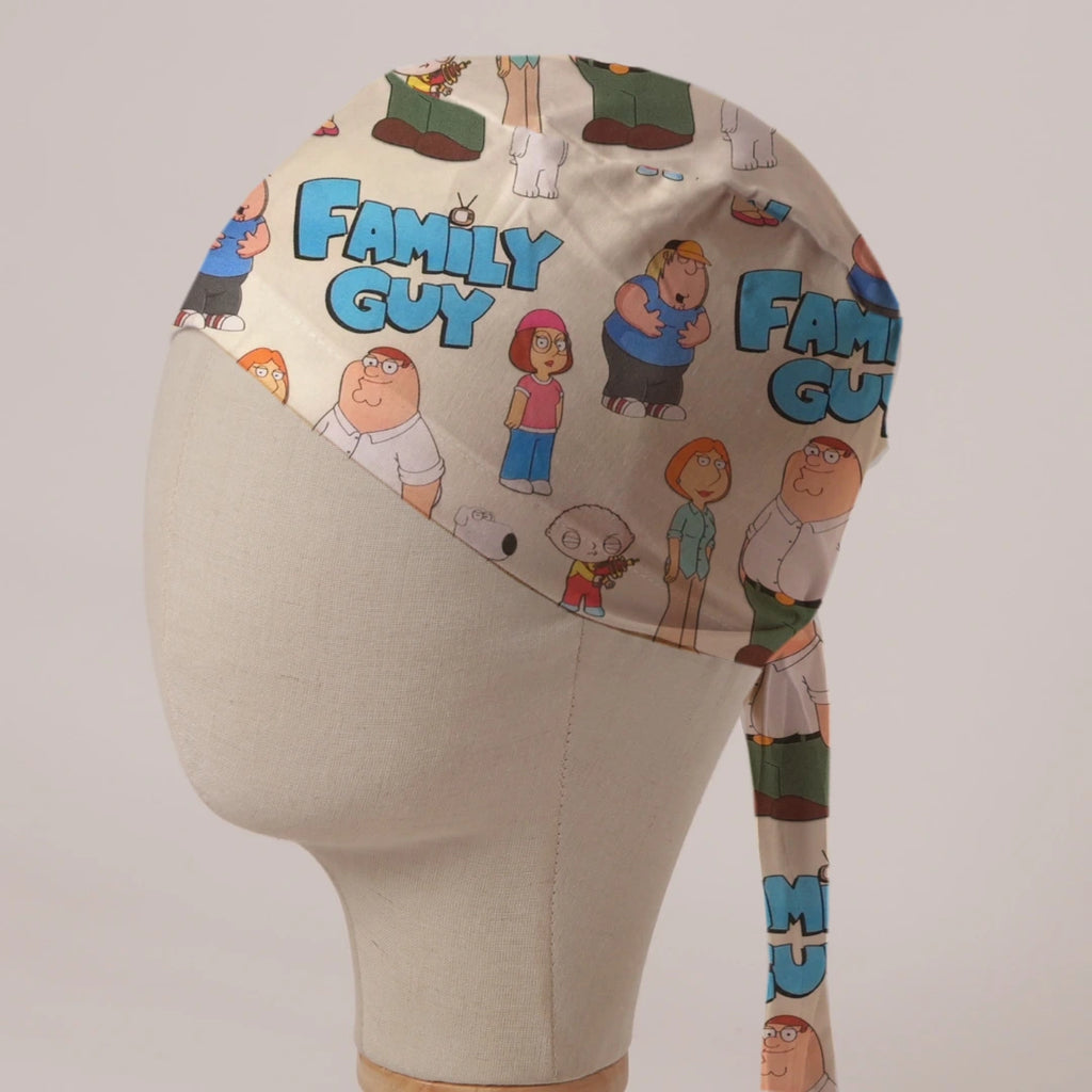 Family Guy Title and Cast fabric scrub cap in Bandana tie-back style: Family Guy title and cast on cream