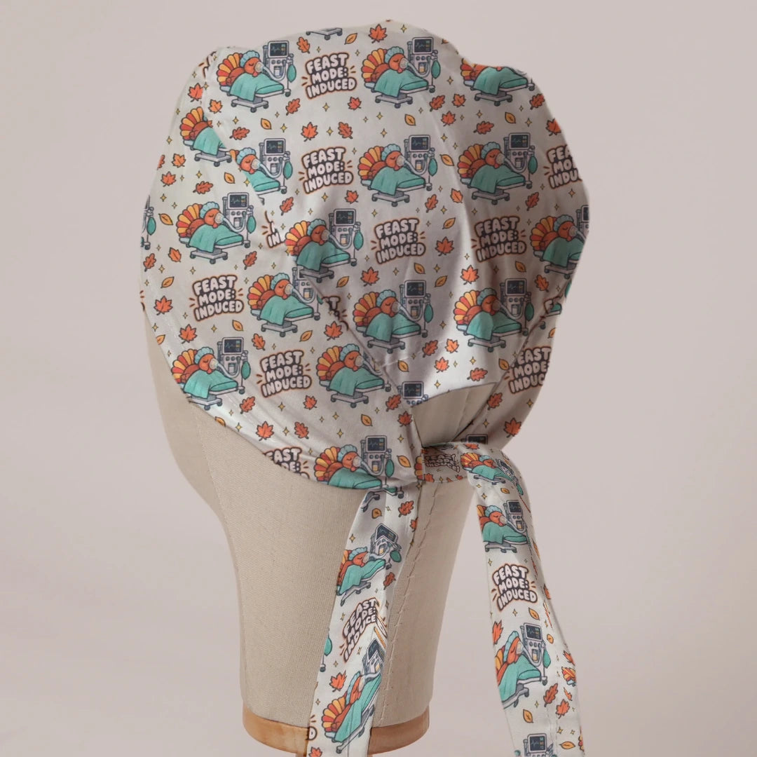 Feast Mode Induced scrub cap in Bandana tie-back style on mannequin head, back view with ties