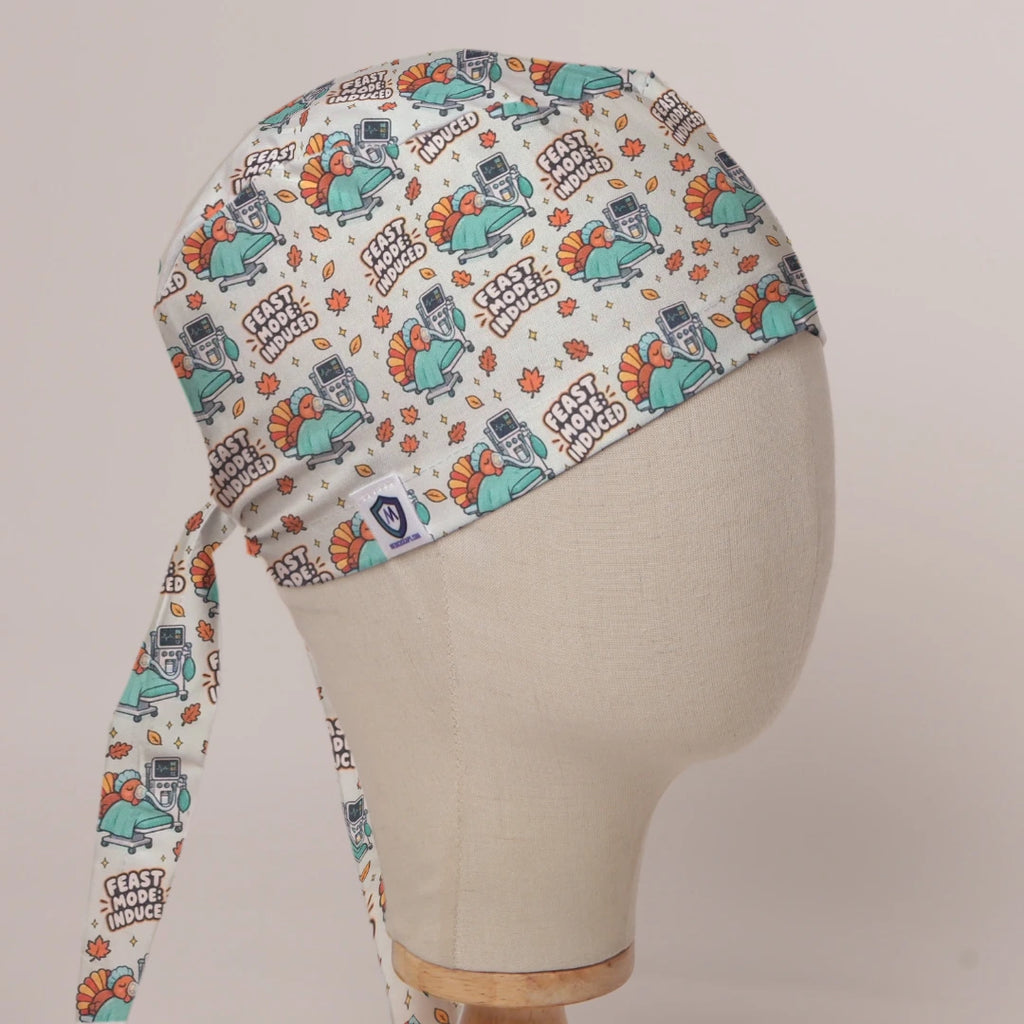 Feast Mode Induced scrub cap in Bandana tie-back style on mannequin head, front right view with the Medicus label