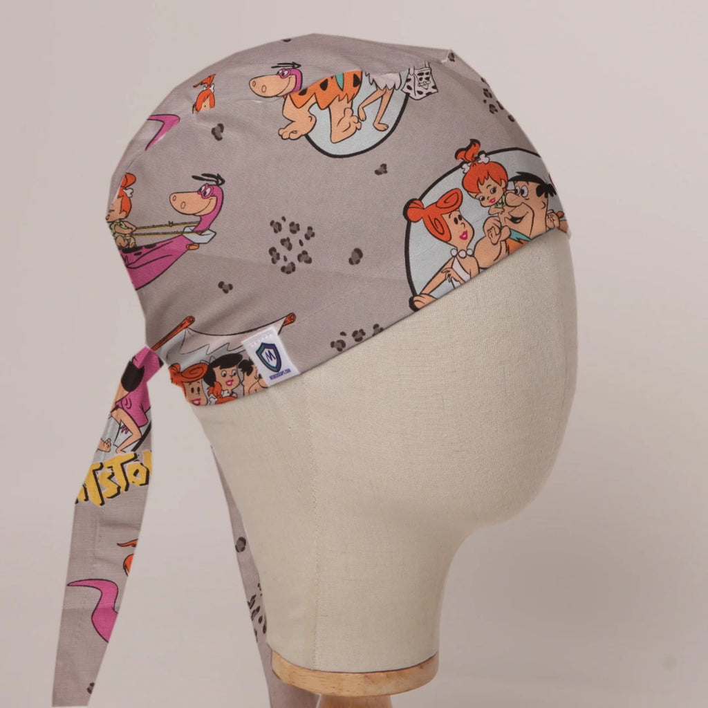 Flintstones in Grey fabric scrub cap in Bandana tie-back style on mannequin head, front right view with the Medicus label