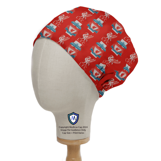 A mannequin head showcases the Football Club Liverpool Scrub Cap by Medicus Scrub Caps, featuring blue crabs, red hearts with LOVE, and blue text, ideal for healthcare professionals. A shield logo with M enhances its football culture theme.