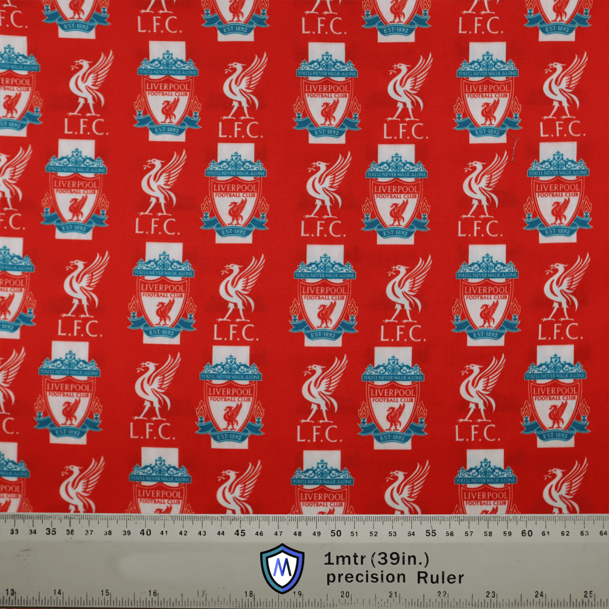 The Medicus Scrub Caps Football Club Liverpool Scrub Cap features a red fabric with repeated Liverpool FC logos, liver birds, and L.F.C. text. Its ideal for healthcare professionals who love football culture. A ruler at the bottom measures 1 meter (39 inches).