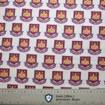 The Medicus Scrub Caps Football Club West Ham United Scrub Cap features a design with repeating gold logos of crossed hammers and a castle on a maroon shield, set against a white background with a precision ruler for scale—perfect for healthcare professionals who are loyal fans.