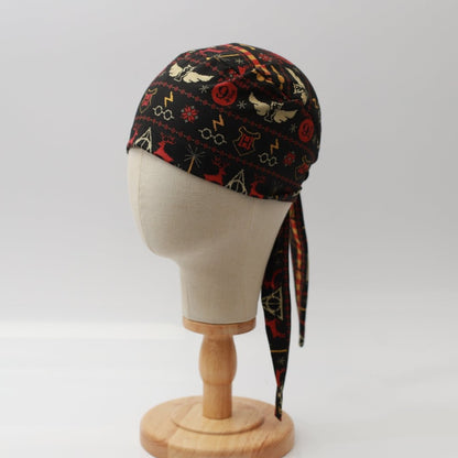Mannequin head wearing Medicus Scrub Cap with Harry Potter Christmas jumper print, on a wooden stand against a white backdrop.