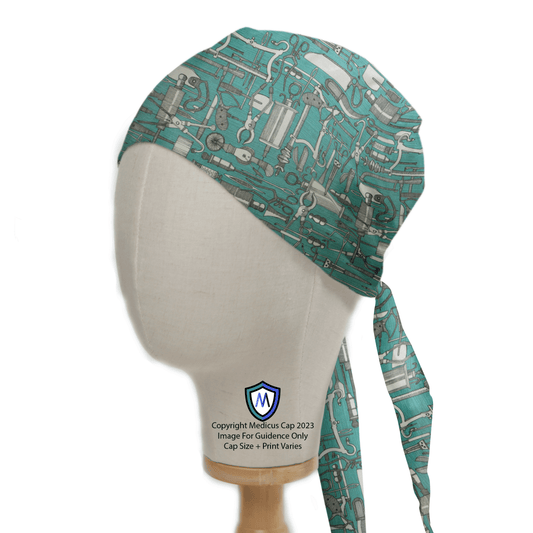 A mannequin head displays the Hospital Tools Surgeons Table On Teal Blue Scrub Cap by Medicus Scrub Caps, designed for healthcare professionals. It ties at the back with the logo on the neck, perfectly complementing any medical uniform.