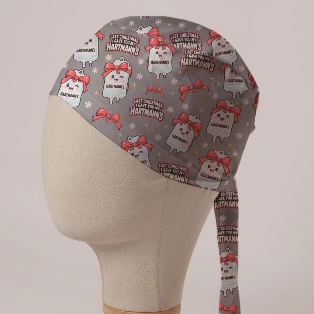 Last Christmas I Gave You My Hartmann's scrub cap: smiling Hartmann's fluid bags tied with red bows and snowflakes on grey