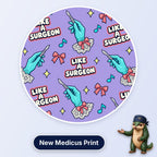 Like A Surgeon scrub cap print: gloved hands holding scalpels with lace cuffs, pink bows and music notes on lilac