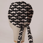Moustaches On Black scrub cap in Bandana tie-back style on mannequin head, back view with ties