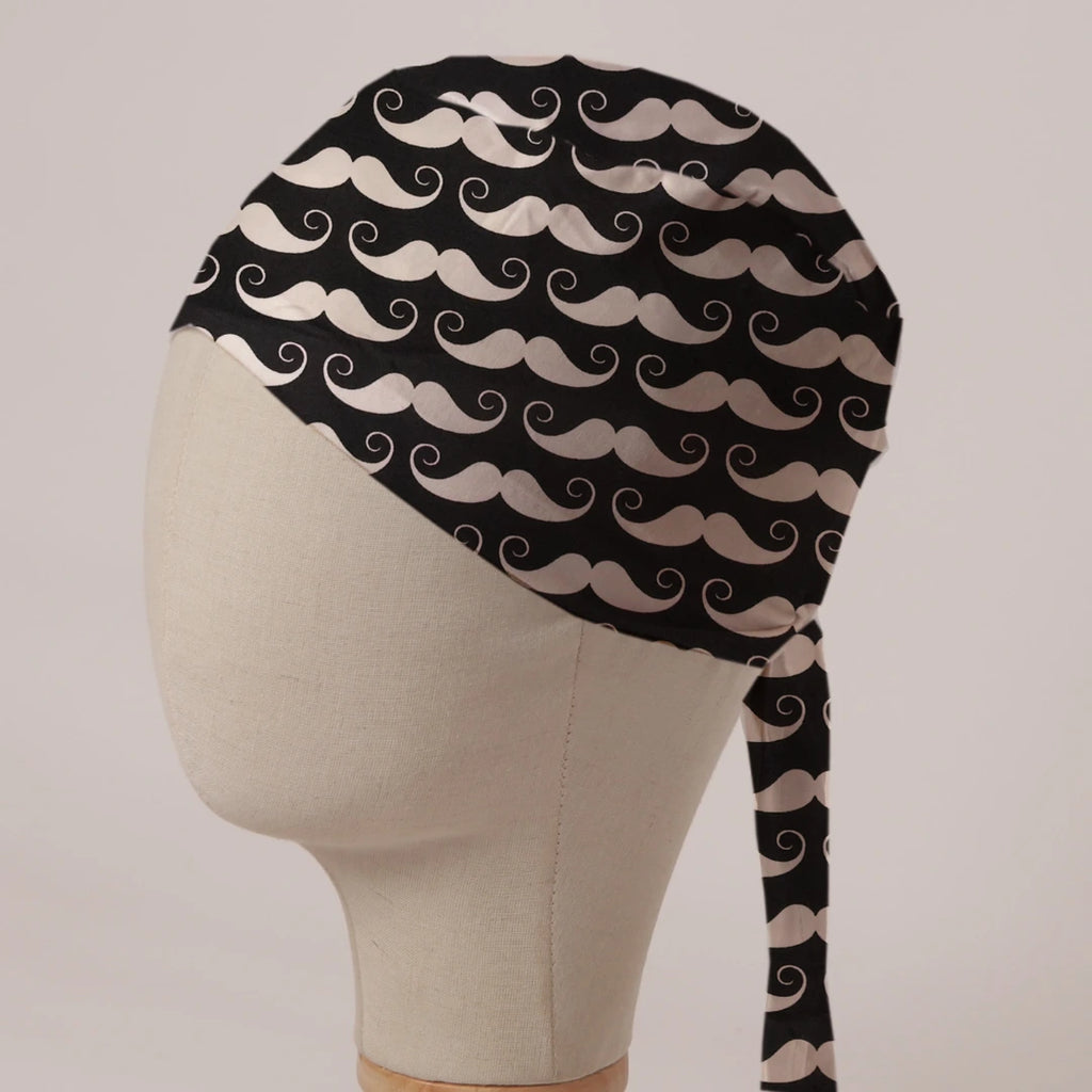 Moustaches On Black scrub cap in Bandana tie-back style: cream handlebar moustaches on black