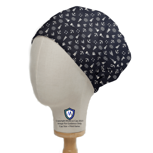 A side view of a mannequin head displays the eco-friendly Nautical Ships Lighthouses On Navy Scrub Cap by Medicus Scrub Caps, featuring a gathered back and adorned with white anchors and ship wheels, elegantly set on a wooden stand.