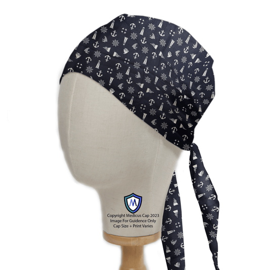 The mannequin head showcases a Medicus Scrub Caps eco-friendly navy scrub cap, featuring nautical ships, lighthouses, and snowflakes. This reusable cap ties in the back with fabric elegantly draping behind and displays a small logo on the side.