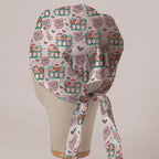 O Come All Ye Theatre Staff scrub cap in Bandana tie-back style on mannequin head, back view with ties