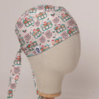 O Come All Ye Theatre Staff scrub cap in Bandana tie-back style on mannequin head, front right view with the Medicus label