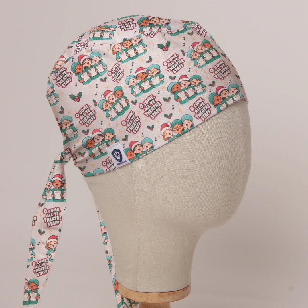 O Come All Ye Theatre Staff scrub cap in Bandana tie-back style on mannequin head, front right view with the Medicus label