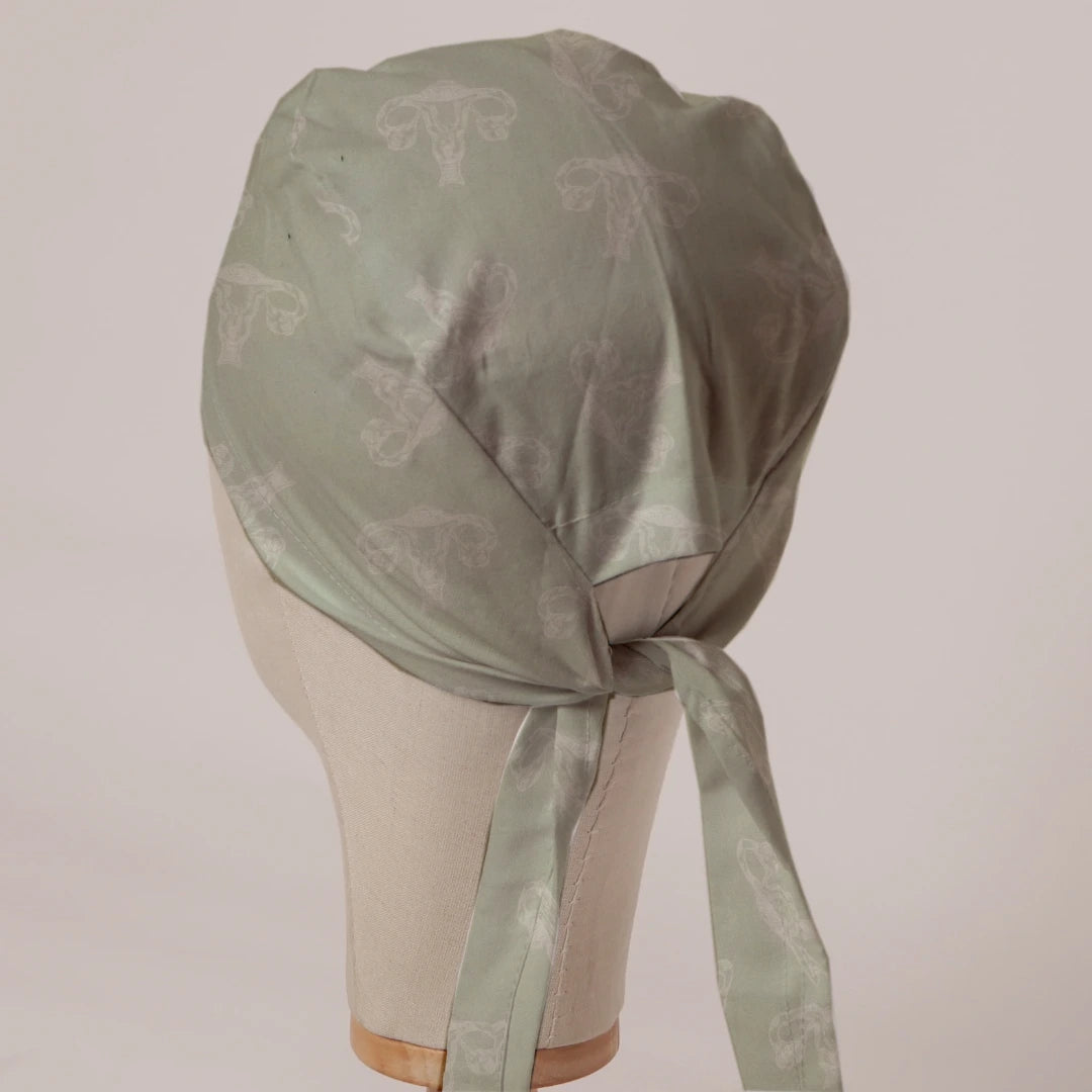OBGYN on Misty Green scrub cap in Bandana tie-back style on mannequin head, back view with ties