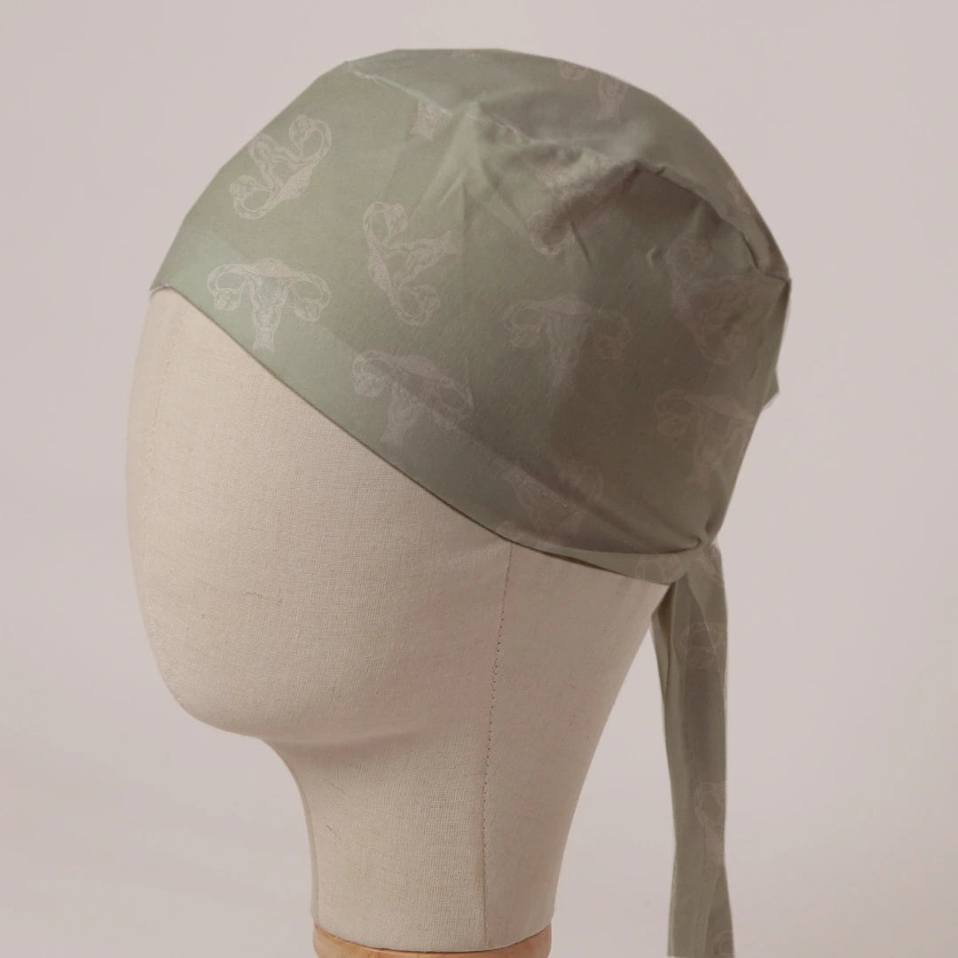 OBGYN on Misty Green scrub cap in Bandana tie-back style: tonal uterus line art on misty green