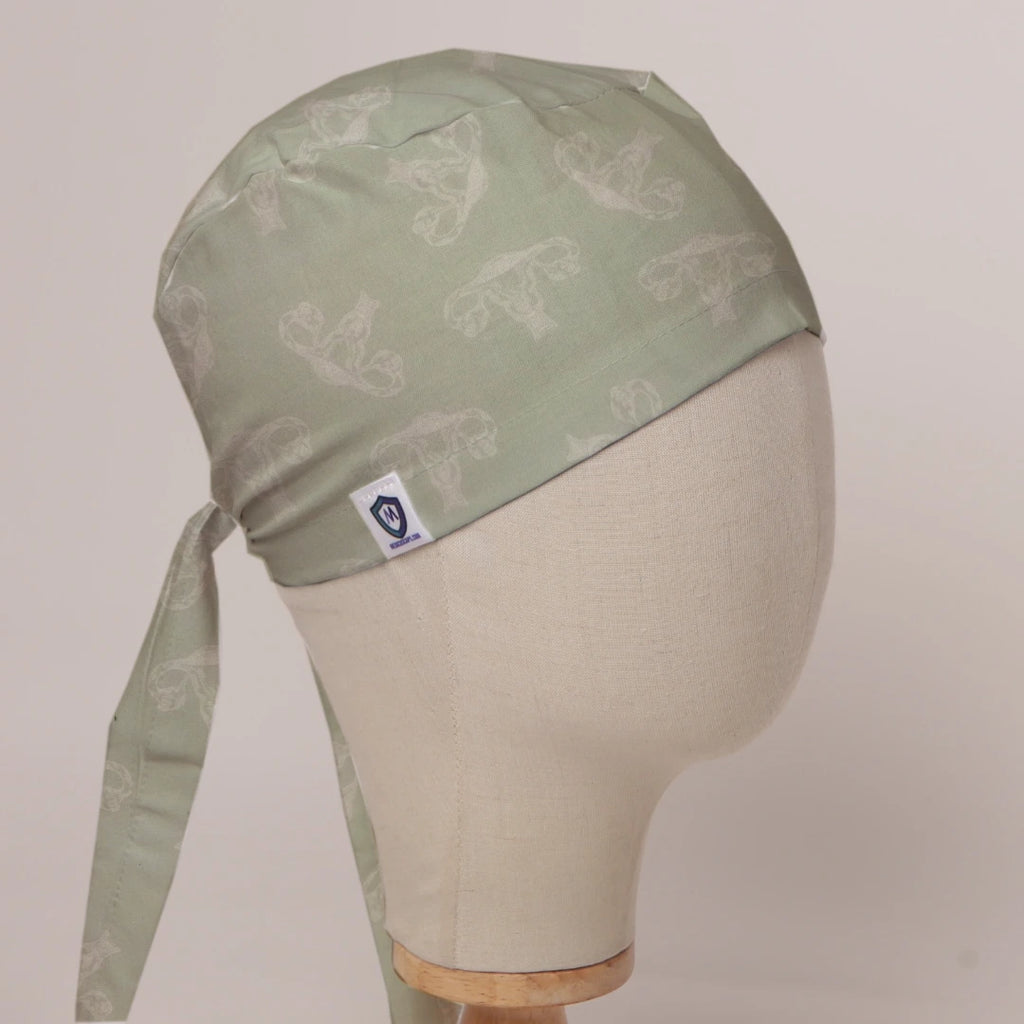 OBGYN on Misty Green scrub cap in Bandana tie-back style on mannequin head, front right view with the Medicus label