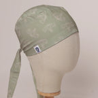 OBGYN on Misty Green scrub cap in Bandana tie-back style on mannequin head, front right view with the Medicus label