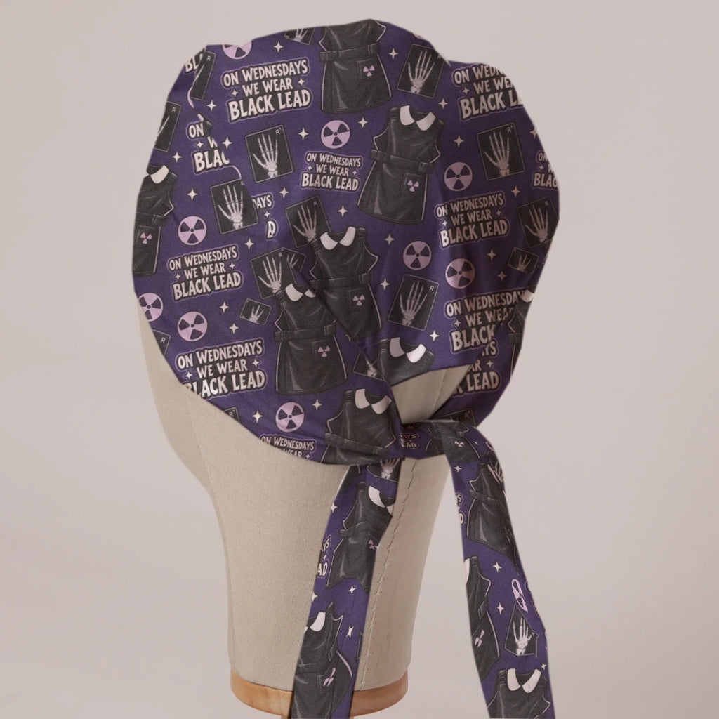 On Wednesdays We Wear Black Lead scrub cap in Bandana tie-back style on mannequin head, back view with ties