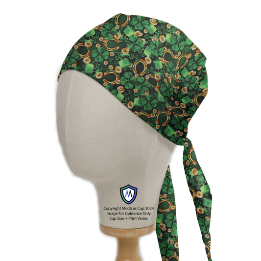 The Paddy Luck Of The Irish Scrub Cap by Medicus Scrub Caps adorns the mannequin head with a floral and chain pattern, offering comfort. This green cap has a long tie at the back, with the brand logo displayed on the mount.