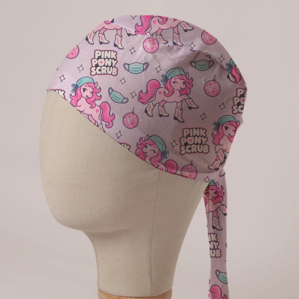 Pink Pony Scrub scrub cap in Bandana tie-back style: pink ponies in scrub caps and cowboy boots with disco balls on pale pink
