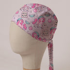 Pink Pony Scrub scrub cap in Bandana tie-back style: pink ponies in scrub caps and cowboy boots with disco balls on pale pink