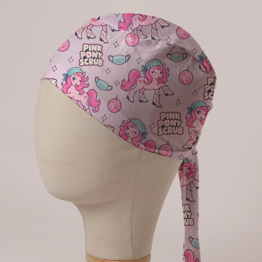 Pink Pony Scrub scrub cap in Bandana tie-back style: pink ponies in scrub caps and cowboy boots with disco balls on pale pink