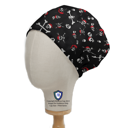 A mannequin head dons a Medicus Scrub Caps Pirate Skulls and Bones Scrub Cap with white skulls, crossbones, and red bandanas. The stylish customizable hat is displayed on a stand with a logo at its base.