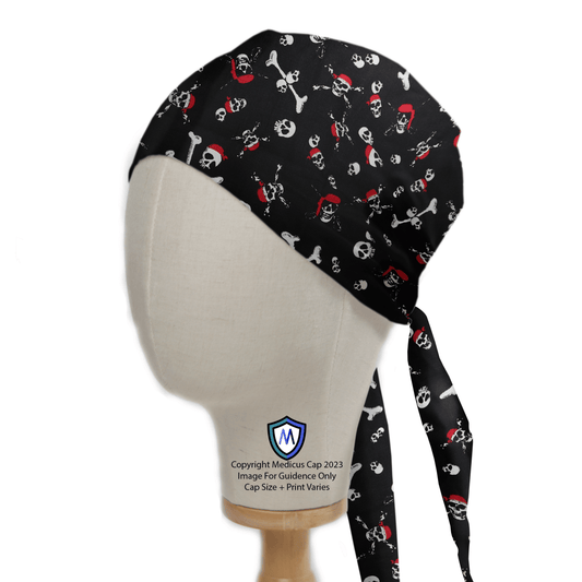 A Medicus Scrub Caps mannequin head features the Pirate Skulls and Bones Scrub Cap, boasting a bold black design with skulls, crossbones, and red pirate motifs. This sustainable cap includes long ties at the back for secure fitting.