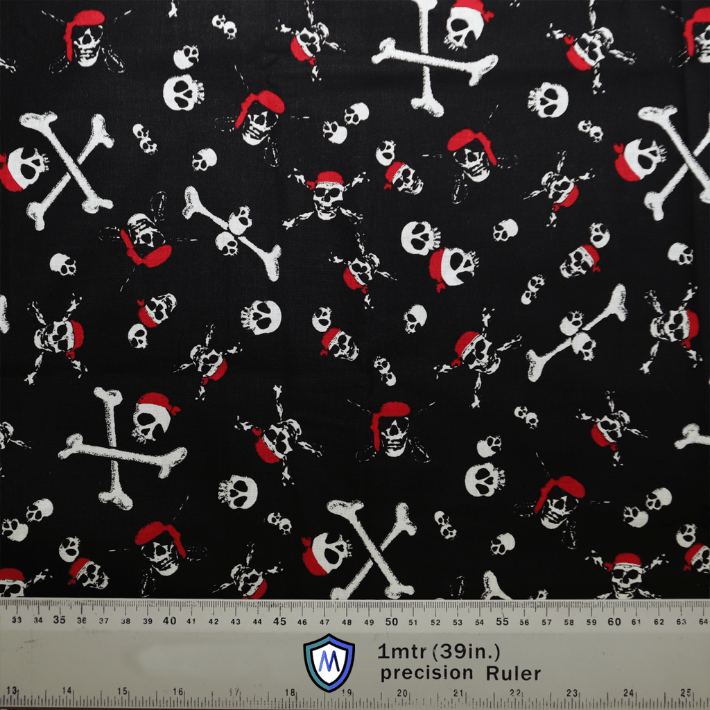 The black fabric features a pirate theme with white skulls and crossbones, some wearing red bandanas. Ideal for crafting a Pirate Skulls and Bones Scrub Cap by Medicus Scrub Caps. A bottom ruler provides measurements in inches and centimeters for precise hat customization.