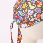 Close-up detail of Pokemon scrub cap showing colorful cartoon characters pattern and tie strings