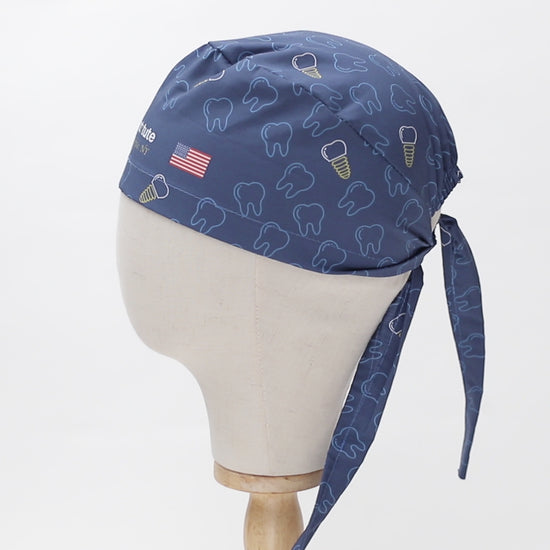 Video of a rotating blue scrub cap with dental patterns and an American flag on a mannequin head.