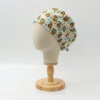 Pun-tastic scrub cap with coffee and pastry pattern on mannequin head, side profile view