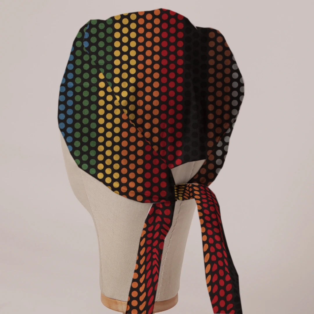 Rainbow Dots scrub cap in Bandana tie-back style on mannequin head, back view with ties