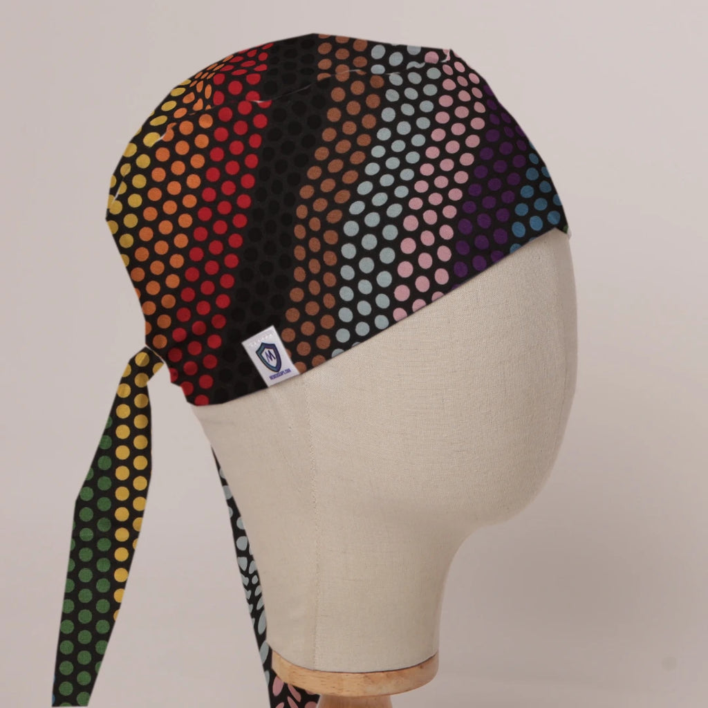Rainbow Dots scrub cap in Bandana tie-back style on mannequin head, front right view with the Medicus label