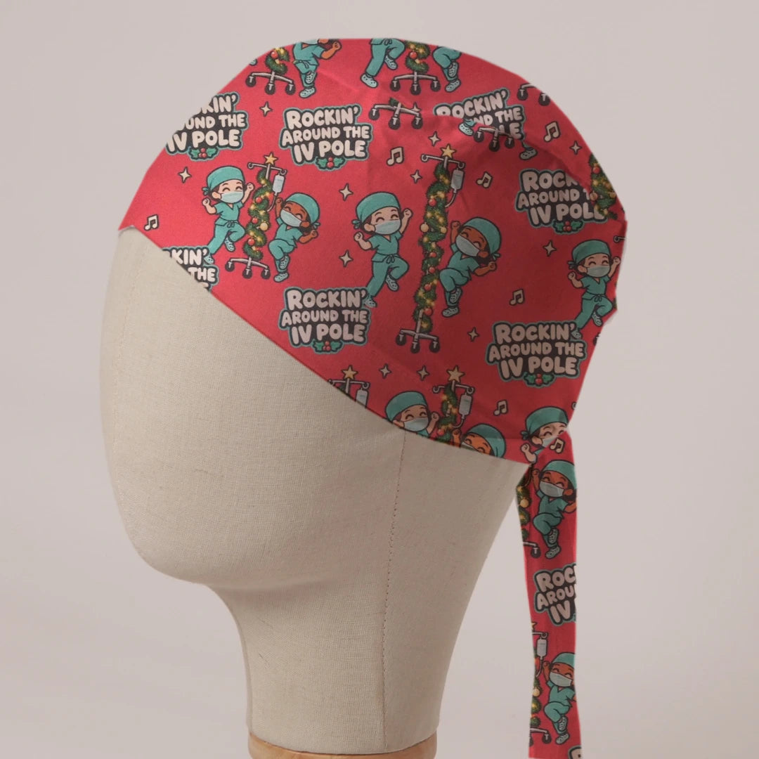 Rockin' Around The IV Pole scrub cap: masked theatre staff dancing around IV poles wrapped in tinsel and lights on red