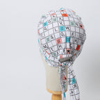 Back view of Scrabble board pattern scrub cap with letter tiles and colorful squares on mannequin head