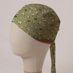 Sheep Fields scrub cap in Bandana tie-back style: black and white sheep on olive green