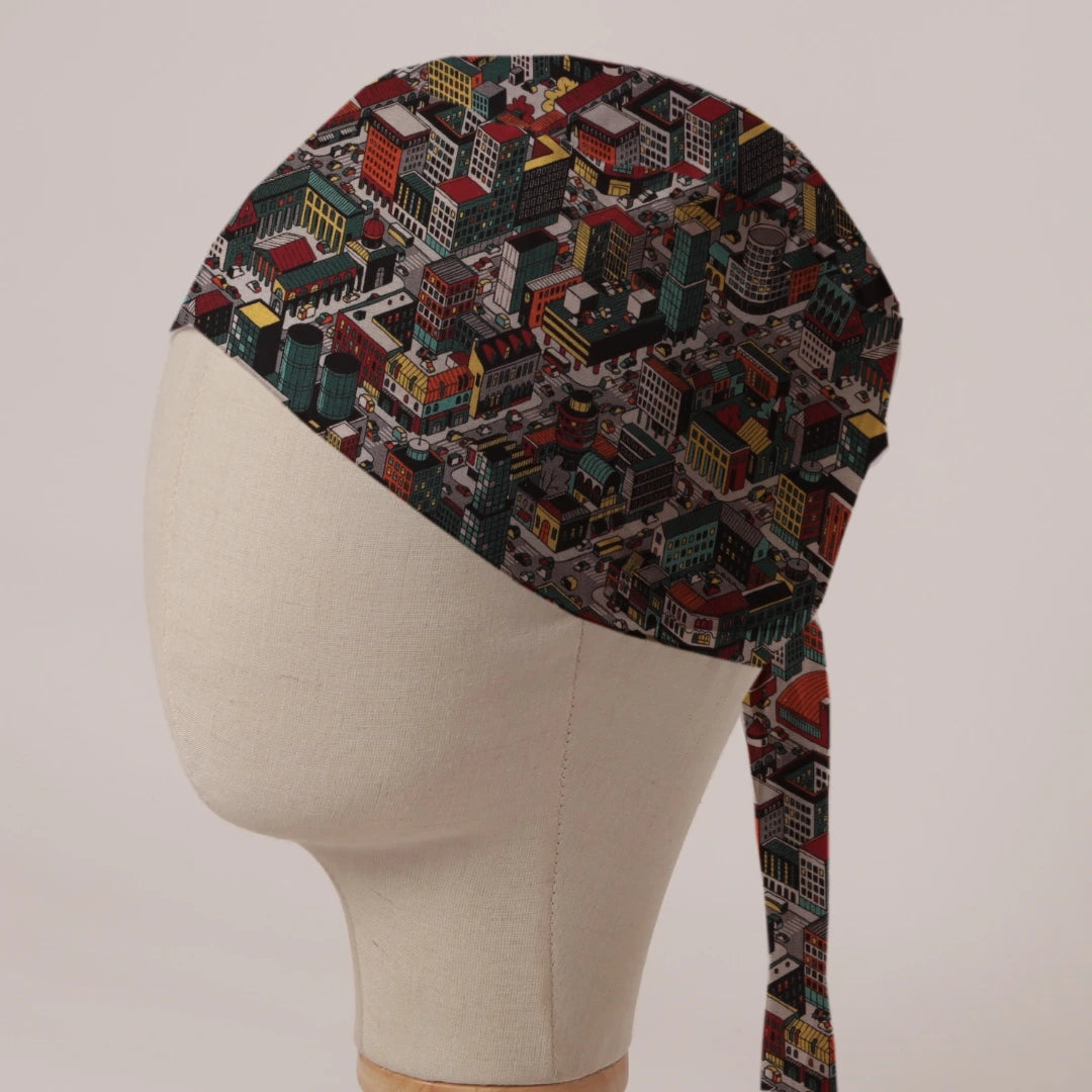 Sim City Inspired Isometric City scrub cap in Bandana tie-back style: isometric cityscape of tower blocks and traffic