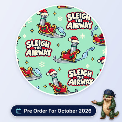Sleigh The Airway scrub cap print: laryngoscopes in Santa hats riding red sleighs with snowflakes on mint green, with a Pre Order For October 2026 badge