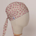 Small Roses On Beige scrub cap in Bandana tie-back style on mannequin head, front right view with the Medicus label