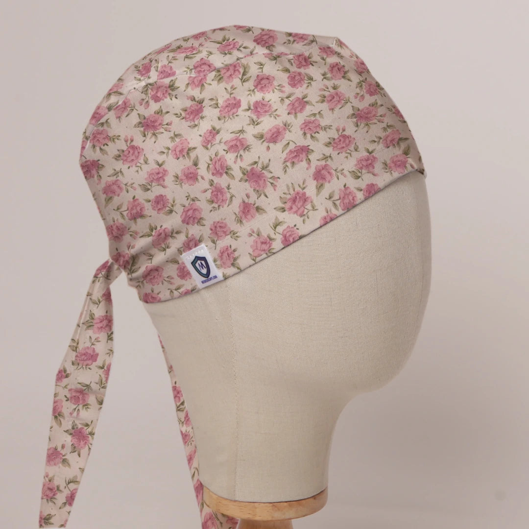 Small Roses On Beige scrub cap in Bandana tie-back style on mannequin head, front right view with the Medicus label
