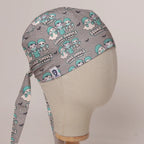 Squad Ghouls Scrubbed & Ready scrub cap in Bandana tie-back style on mannequin head, front right view with the Medicus label