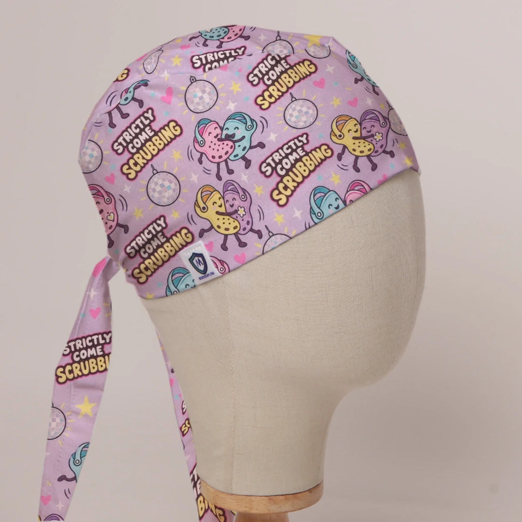 Strictly Come Scrubbing scrub cap in Bandana tie-back style on mannequin head, front right view with the Medicus label