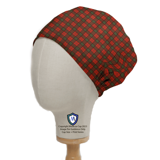 A head mannequin displays the Tartan Scottish Red Green Scrub Cap by Medicus Scrub Caps, showcasing its red and green plaid celebrating Scottish heritage. The caps fabric includes a small blue and white shield logo, emphasizing its unique reusable design.