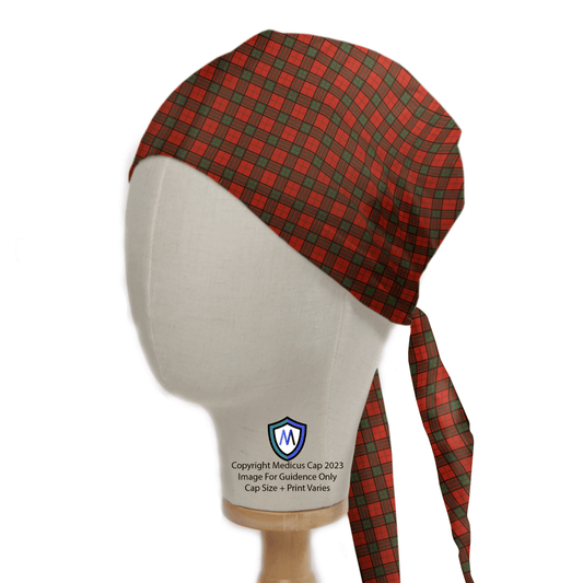 A mannequin head showcases the Tartan Scottish Red Green Scrub Cap, celebrating Scottish heritage with its red and green plaid design. Featuring a tied back, this reusable cap is copyrighted by Medicus Scrub Caps 2023.