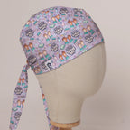 The Great British Scrub Off scrub cap in Bandana tie-back style on mannequin head, front right view with the Medicus label