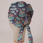 This Is Fine, The Field Is Dry scrub cap in Bandana tie-back style on mannequin head, back view with ties