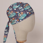 This Is Fine, The Field Is Dry scrub cap in Bandana tie-back style on mannequin head, front right view with the Medicus label