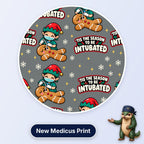 Tis The Season To Be Intubated scrub cap print: an elf anaesthetist intubating a gingerbread man with snowflakes on grey